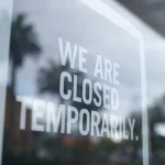 'we are temporarily closed' sign on window of shop/business