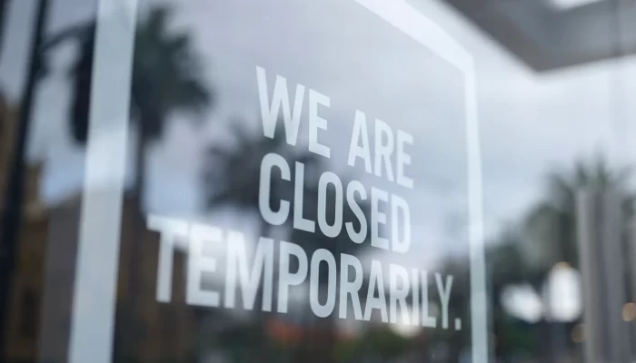 'we are temporarily closed' sign on window of shop/business