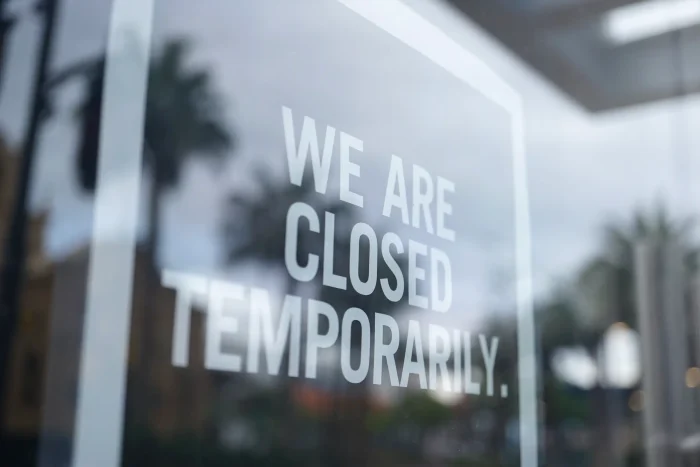 'we are temporarily closed' sign on window of shop/business